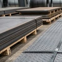 Mild steel plate banded in stacks on pallets in the warehouse