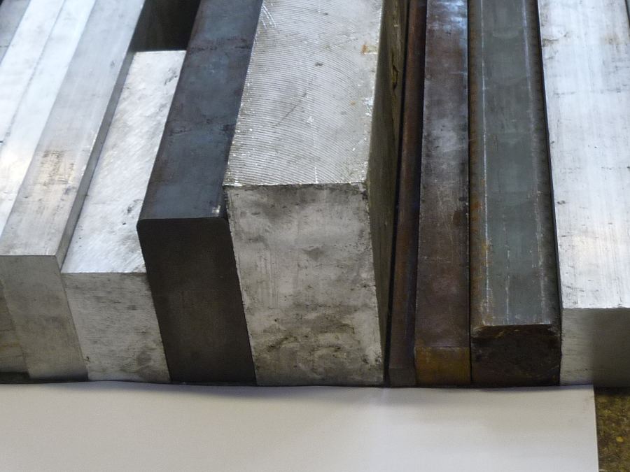 Ends of square and rectangular steel bar sections lined up