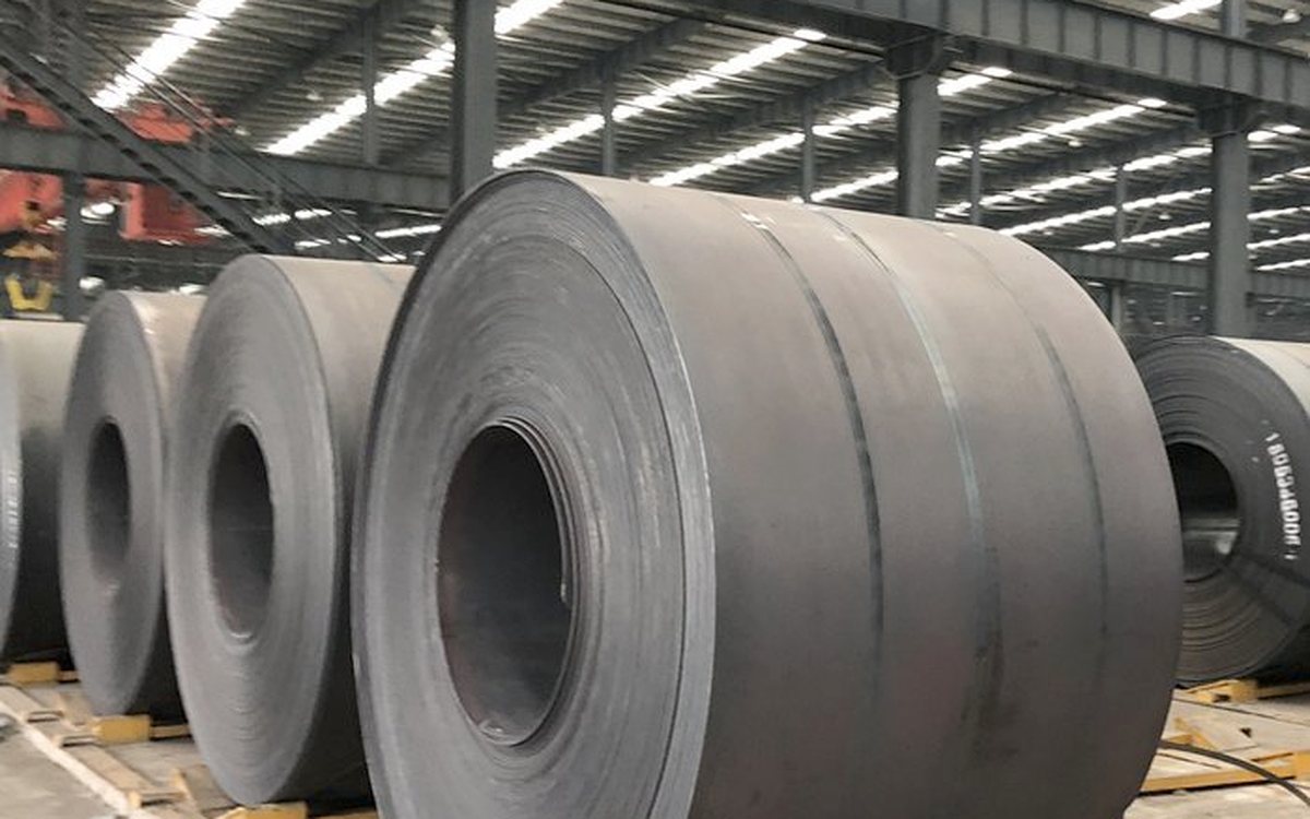 Hot rolled coil with dark mill scale, stacked on timber bearers in the warehouse