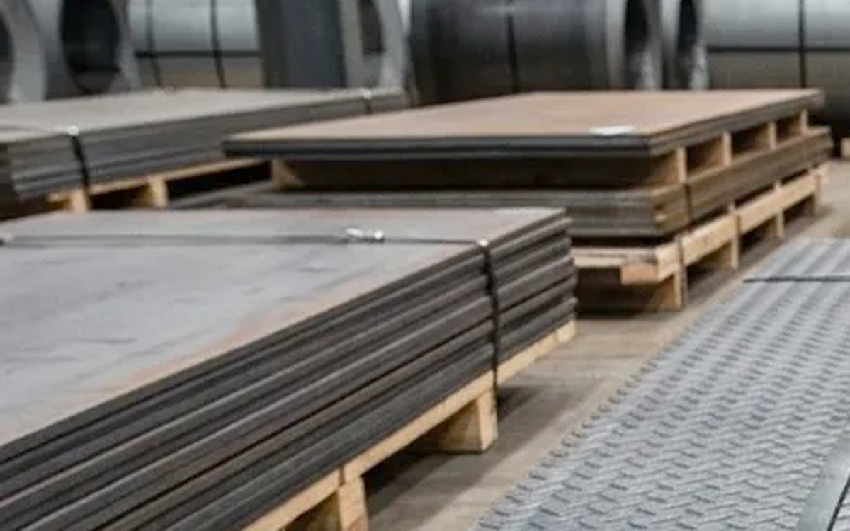 Mild steel plate banded in stacks on pallets in the warehouse