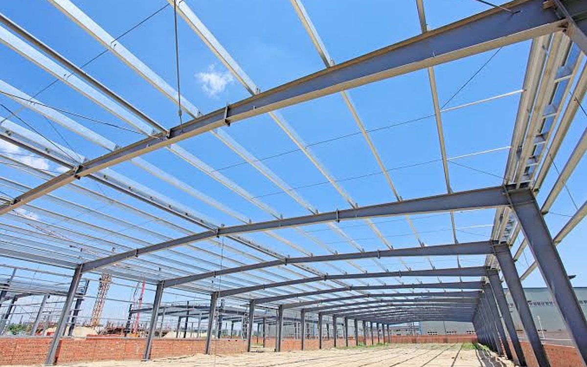 Steel portal frame with purlins across the roof of a new shed