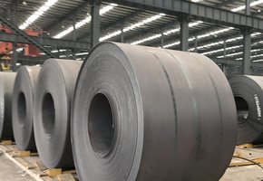 Hot rolled coil with dark mill scale, stacked on timber bearers in the warehouse